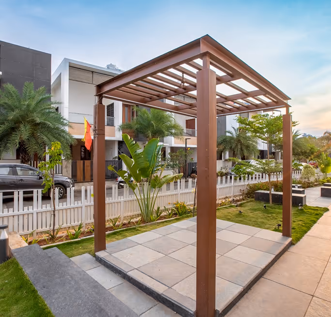 A timber pergola over a seating area in the Blessed grounds.