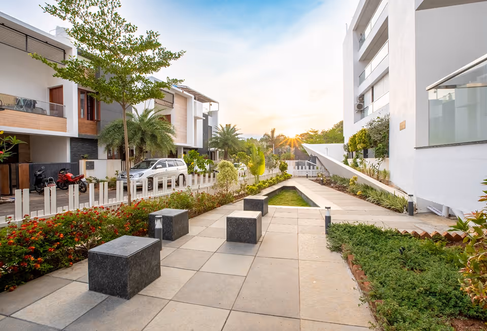 A landscaped walkway running through the Blessed grounds at dusk.