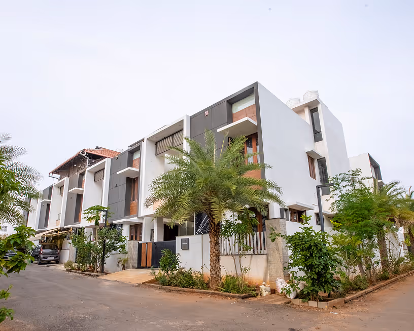 Stepped white terraces of the Happiness 1 villas seen along the street.