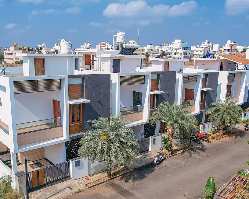 Happiness 1 villas seen across a landscaped courtyard.